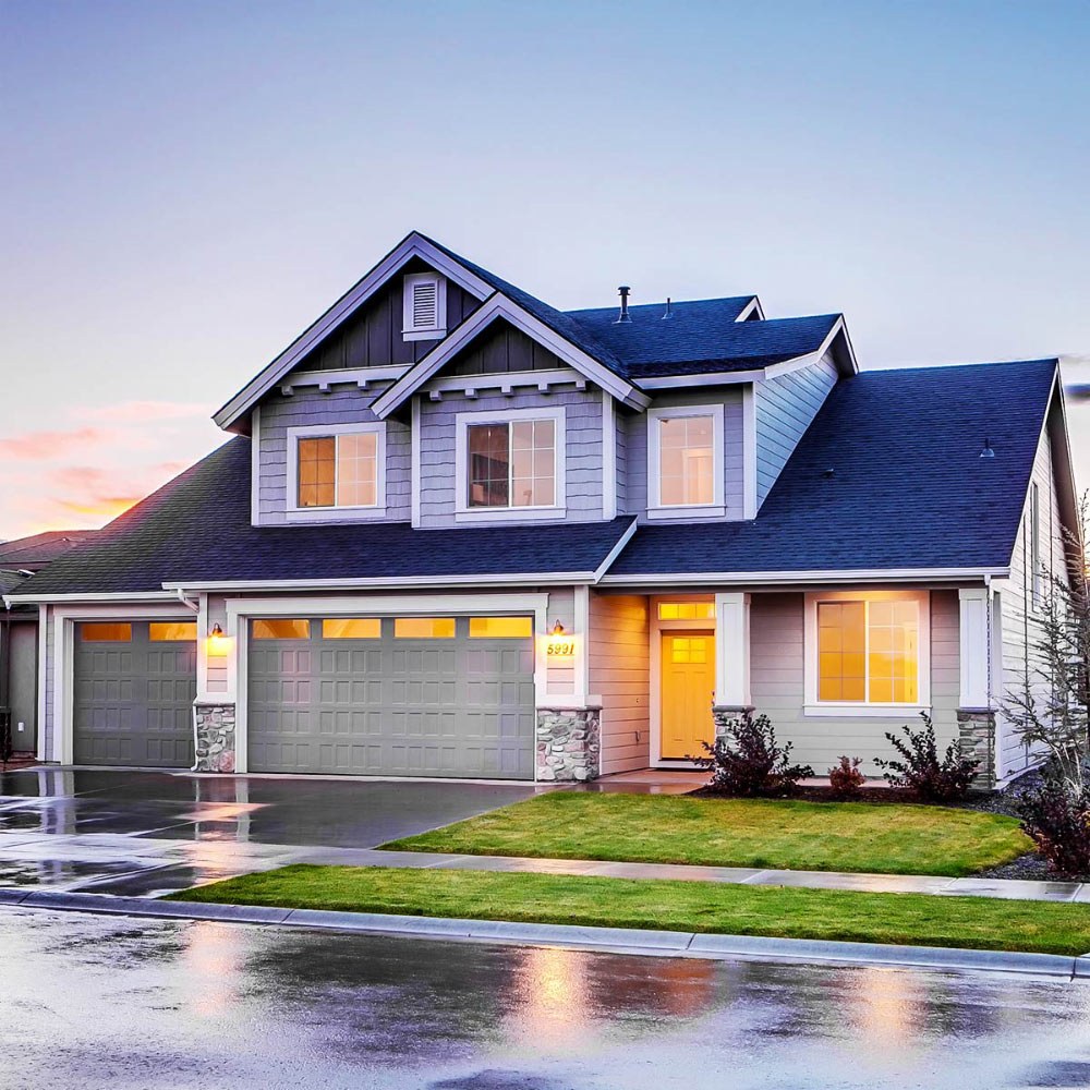 A Metroplex home at dusk with its windows lit
